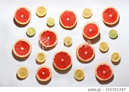 Flat lay composition with tasty ripe grapefruit slices on white background Flat lay composition with tasty ripe grapefruit slices on white background 103701397