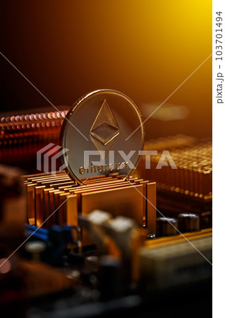 Ethereum coin on a computer motherboard 103701494
