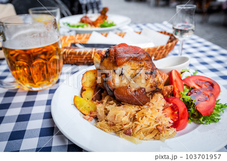 Bavarian traditional food plate, pork hock baked with beer, Schweinshaxe. 103701957