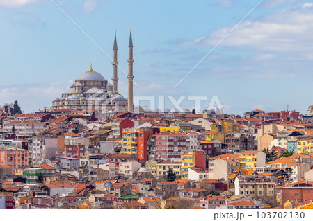 Suleymaniye mosque with colorful residential house area in Istanbul with blue sky background, Turkey, Istanbul Mosque Suleymaniye minaret with colorful house, Beautiful view Istanbul, Turkiye. 103702130