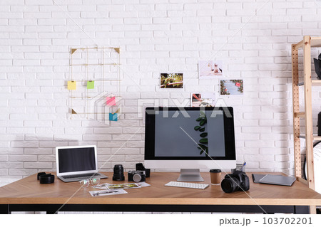 Photographer's workplace with professional camera in office Photographer's workplace with professional camera in office 103702201