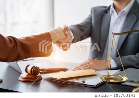 partner lawyers attorneys shaking hands after discussing a contract agreement done. 103703143