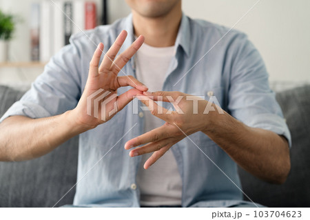 Happy young deaf man using sign Language to communicate with other people.. Happy young deaf man using sign Language to communicate with other people.. 103704623
