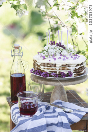 beautiful cake with candles on the background of nature beautiful cake with candles on the background of nature 103705975