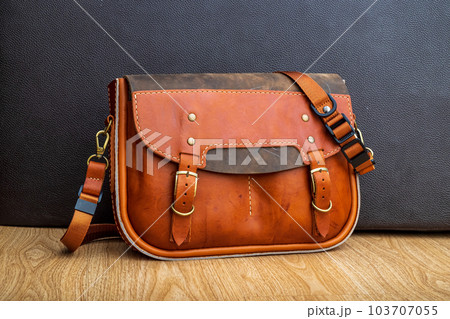Hand made Genuine Leather Messenger Bag on the floor Hand made Genuine Leather Messenger Bag on the floor 103707055