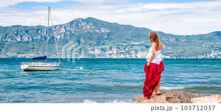 Woman in red dress staying at the lake Woman in red dress staying at the lake 103712037