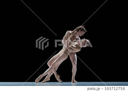 Love and passion. Young people, man and woman, professional ballet dancers making performance against black studio background Love and passion. Young people, man and woman, professional ballet dancers making performance against black studio background 103712758