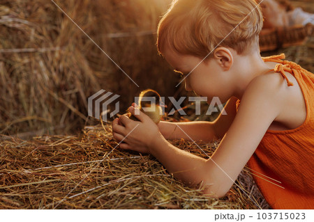 Child holding a duck 103715023