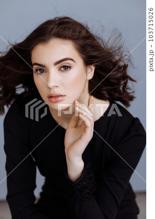 Young beautiful brunette in the studio 103715026