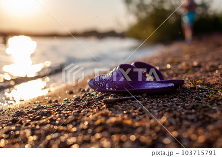 Close-up of the shore of a lake or river made of small stones against 103715791