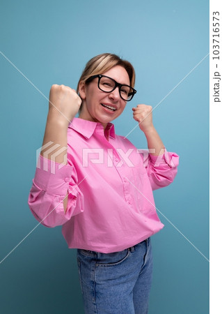 young smart blond caucasian secretary woman with glasses and ponytail dressed in a pink blouse 103716573