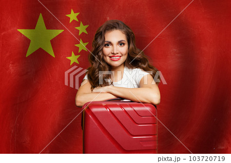 Beautiful woman with red suitcase on the People's Republic of China flag background. Beautiful woman with red suitcase on the People's Republic of China flag background. 103720719