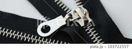 Open and closed metal zippers for clothing on white background 103722557