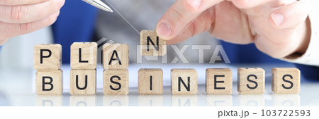 Businessman collecting words plan business with wooden cubes Businessman collecting words plan business with wooden cubes 103722593
