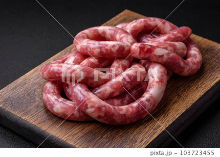 Raw sausages from pork or beef with salt, spices and herbs Raw sausages from pork or beef with salt, spices and herbs 103723455