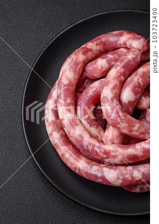 Raw sausages from pork or beef with salt, spices and herbs 103723490