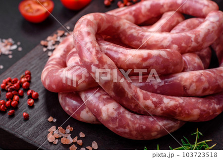 Raw sausages from pork or beef with salt, spices and herbs 103723518