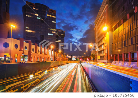 Lisbon cityscape at dusk - street traffic with long exposure motion blurred car lights trails in Amoreiras, Lisbon, Portugal 103725456