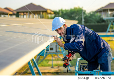 Solar panel station, Engineer installing solar panel at solar energy farm field Solar panel station, Engineer installing solar panel at solar energy farm field 103726178