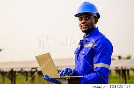 Maintenance engineer installing solar panels on solar cell farm Maintenance engineer installing solar panels on solar cell farm 103726417