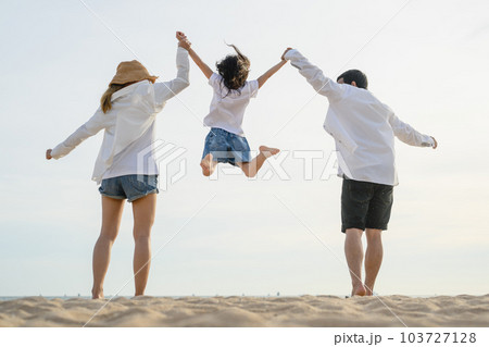 Happy family enjoying together on beach on holiday vacation 103727128