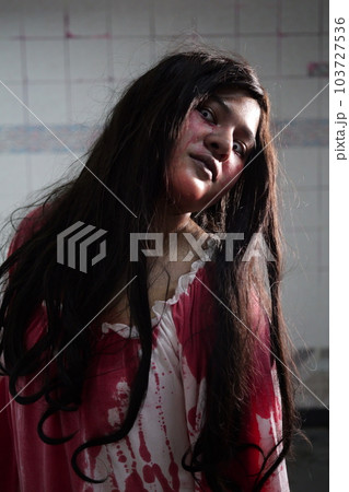 Scary woman in white dress with bloodstain after murder, Halloween concept 103727536
