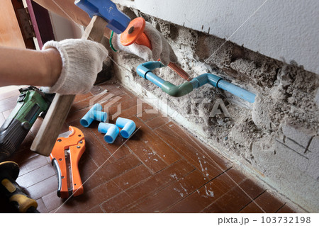 Plumber must open a wall to access a broken pipe. 103732198