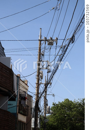 様々なケーブルや電線とそれらを支える電柱 103732569