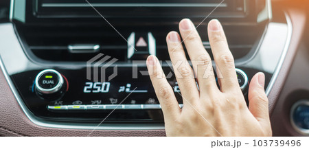 Woman hand checking the air flowing during driving car on the road, air conditioner cooling system inside the car. Adjust, temperature and transport concept Woman hand checking the air flowing during driving car on the road, air conditioner cooling system inside the car. Adjust, temperature and transport concept 103739496