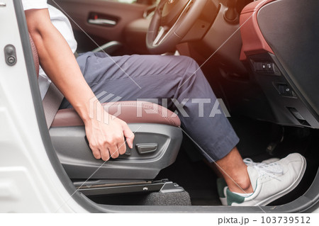 Hand adjust car seat before drive on the road . Ergonomic and safety transportation concept Hand adjust car seat before drive on the road . Ergonomic and safety transportation concept 103739512