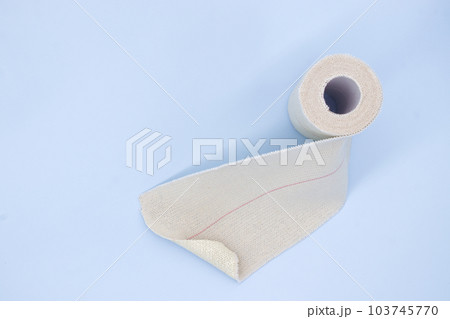 Elastic adhesive bandage on blue background, strong and stretchy Elastic adhesive bandage on blue background, strong and stretchy 103745770