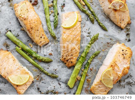 Baked Delicious salmon, green asparagus and lemon in pan 103746749