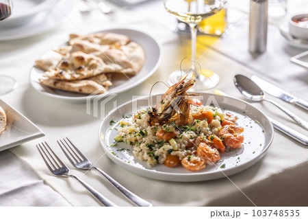 Italian creamy shrimp and zucchini risotto with a decorative shrimp on top 103748535