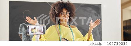 Skilled African-American teacher shoots video lesson for clothes design course in studio 103750053