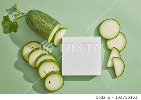 Square podium in white color displayed on pastel background with winter melon slices. Winter melon (Benincasa hispida) may reduce the threat of several types of cancers 103750163