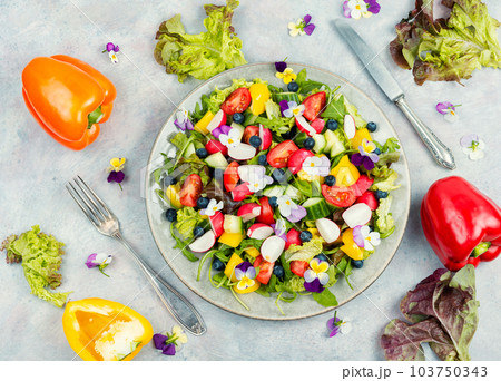 Tasty summer salad with edible flowers 103750343