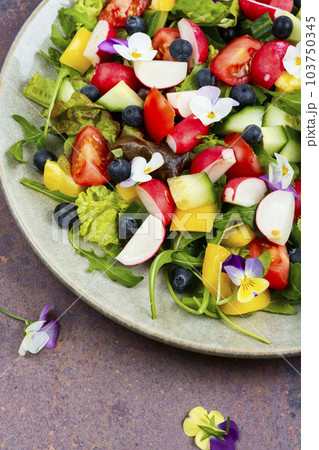 Tasty summer salad with edible flowers 103750345