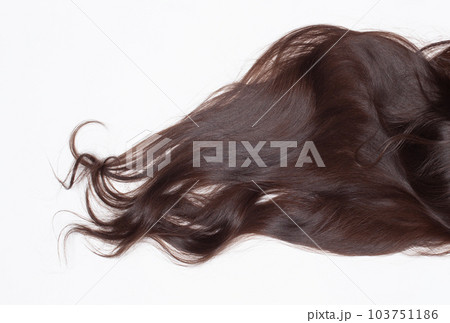 Long wavy healthy brown hair on white background 103751186