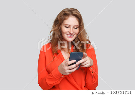 Happy smiling woman using smartphone, studio portrait 103751711