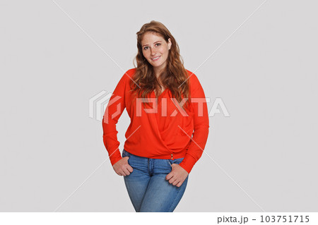 Cheerful woman wearing red shirt standing on white background 103751715