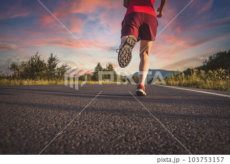 Fitness blonde woman running on the asphalt road at the mountains Fitness blonde woman running on the asphalt road at the mountains 103753157