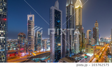 Aerial view of Dubai International Financial District with many skyscrapers day to night timelapse. Aerial view of Dubai International Financial District with many skyscrapers day to night timelapse. 103762575