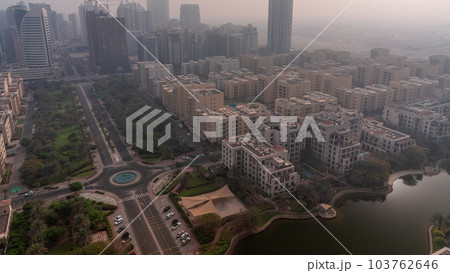 Skyscrapers in Barsha Heights district and low rise buildings in Greens district aerial timelapse during sunrise. 103762646