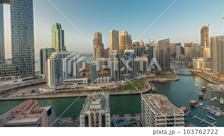 Panorama showing Dubai Marina skyscrapers and JBR district with luxury buildings and resorts aerial timelapse Panorama showing Dubai Marina skyscrapers and JBR district with luxury buildings and resorts aerial timelapse 103762722