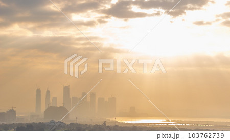 Sunrise over Dubai Creek Harbor with skyscrapers and towers under construction aerial timelapse 103762739