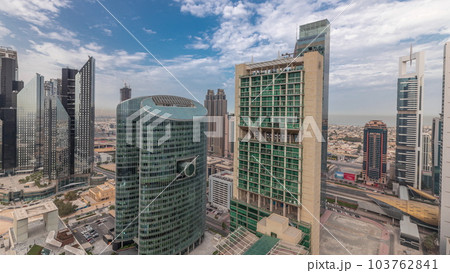 Panorama showing Dubai international financial center skyscrapers with promenade on a gate avenue aerial timelapse. 103762841