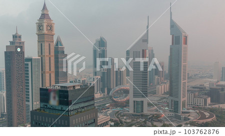 Skyscrapers on Sheikh Zayed Road and DIFC night to day timelapse in Dubai, UAE. 103762876