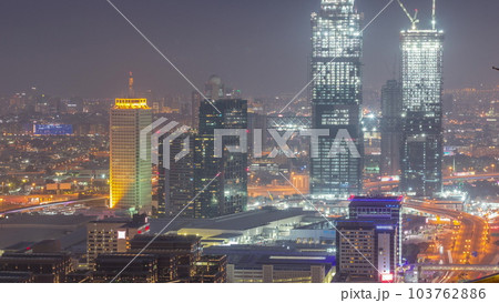Aerial view of skyscrapers with World Trade center in Dubai day to night timelapse. 103762886