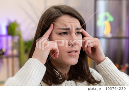 Displeased young woman rubbing temples to cure headache problem, suffering from migraine, stress 103764220