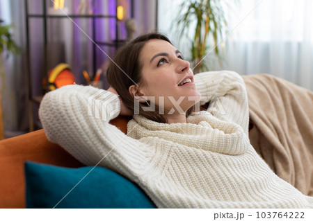 Tired lazy woman enjoy relaxing on home sofa resting napping after hard working day, closed her eyes 103764222